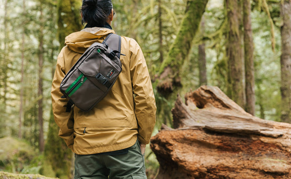Person wearing the LGD sling-style, on a walk in the woods.